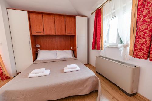 a bedroom with a bed with two towels on it at Villa Heaven in Donji Zemunik
