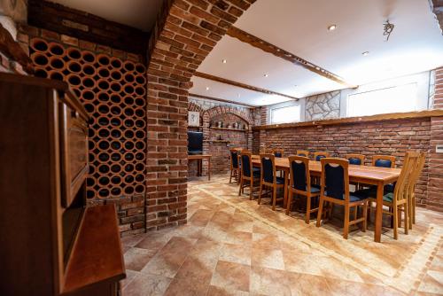 a dining room with a brick wall and a table and chairs at Villa Heaven in Donji Zemunik