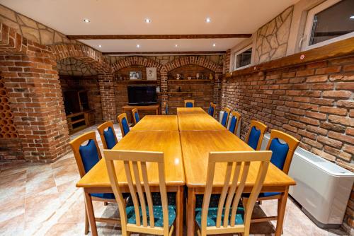 a dining room with a wooden table and chairs at Villa Heaven in Donji Zemunik