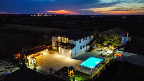 an aerial view of a house with a swimming pool at Villa Heaven in Donji Zemunik