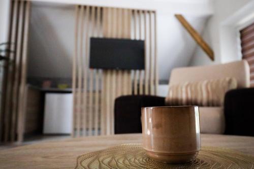 a coffee cup sitting on a table in a living room at Domaćin Komšijska Gostiona in Zrenjanin