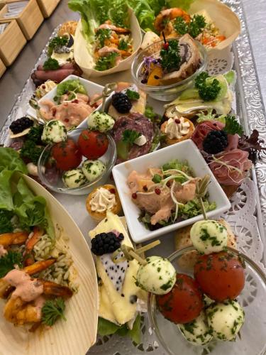 a table full of different types of food on plates at Landhaus Gräfendhron in Gräfendhron