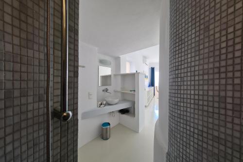 a white bathroom with a sink and a shower at Villa Pastorale Paros in Parikia