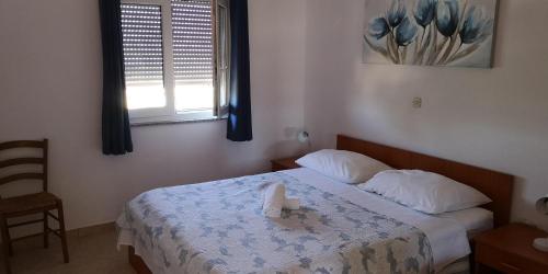 a bedroom with a bed with a candle on it at Aurora Apartments-Nin- 25m to the Beach in Nin