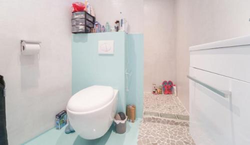 a bathroom with a white toilet in a room at Solo traveler's best stop near Paris in Bagnolet