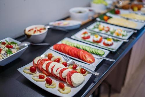 a table with many plates of food on it at GLAMOUR - Restaurant & SPA in Przeźmierowo