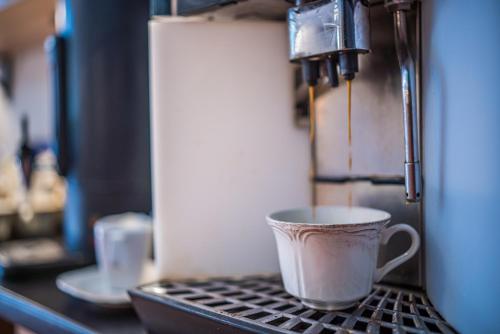 a coffee cup sitting on top of a counter at GLAMOUR - Restaurant & SPA in Przeźmierowo