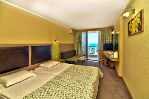 a hotel room with a bed and a balcony at Hotel Slavuna in Albena