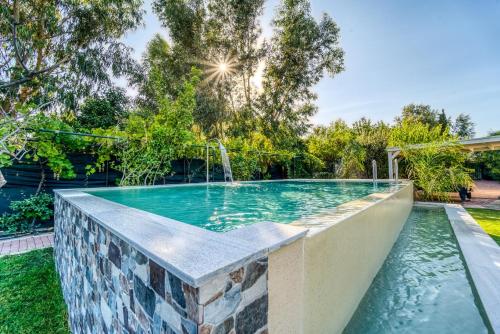 a swimming pool in the backyard of a house at Heliophos Villa Aitheria in Kiotari