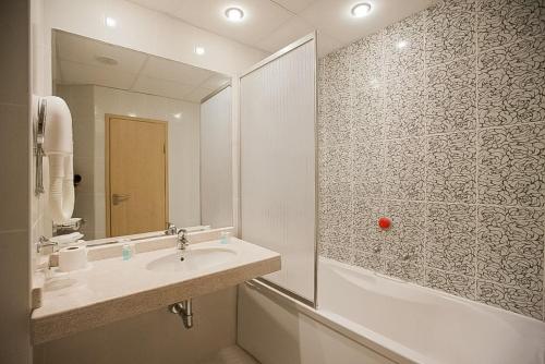 a bathroom with a sink and a shower at Hotel Slavuna in Albena