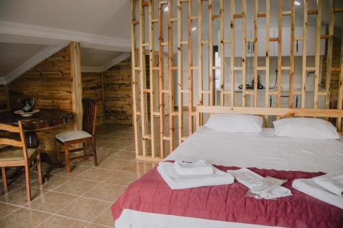 a bedroom with a bed and a wooden wall at Ağva Marina House in Istanbul