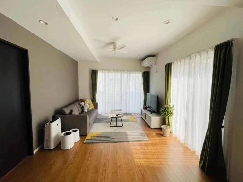 a living room with a couch and a tv at Fujisawa - House - Vacation STAY 88722 in Fujisawa