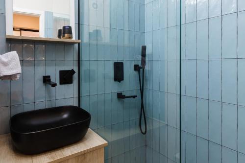 a bathroom with a black ottoman in a shower at Joy City Stay Victoriei 7D-8 in Timişoara
