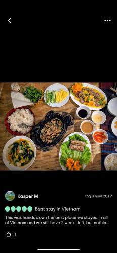 a table with many different dishes of food on it at Tam Coc Wonderland Bungalow in Ninh Binh