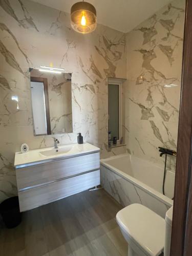 a bathroom with a sink and a tub and a toilet at Airport Accommodation Bedroom with Bathroom, balcony, aircondition, self checkIn, 24 hours check-in after 3pm in Mqabba