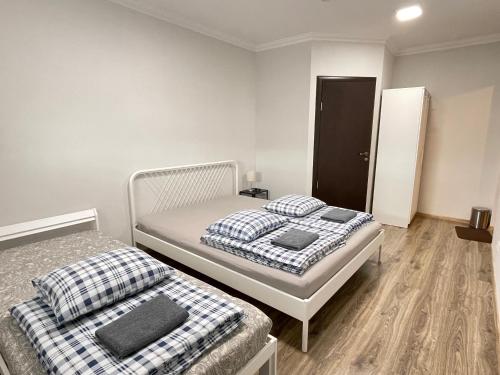 a bedroom with two beds and a closet at Anna's guesthouse in Rīga