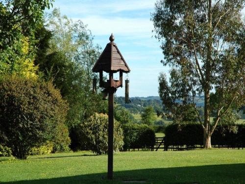 a bird feeder on a pole in a park at Stable Lodge in Drymen