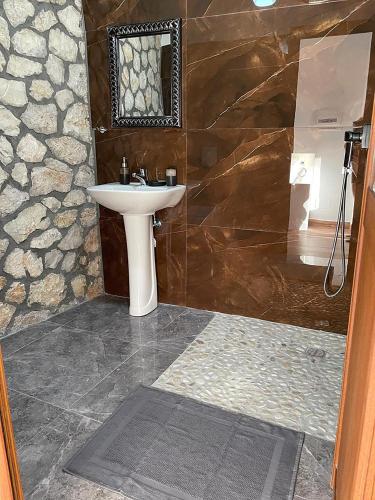 a bathroom with a sink and a shower at Vila Dena in Vlorë