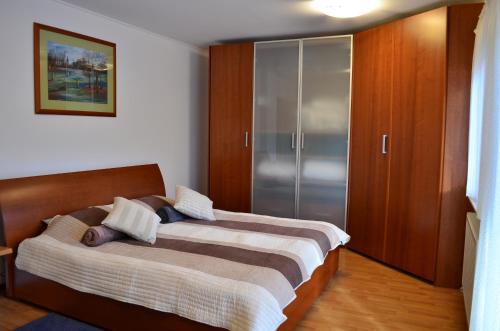 a bedroom with two beds and a closet at Holiday house with a parking space Ozalj, Karlovac - 19578 in Ozalj