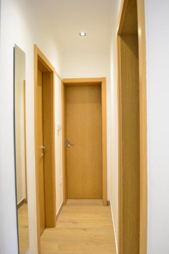 a hallway with two doors and a wooden floor at Holiday house with a parking space Ozalj, Karlovac - 19578 in Ozalj