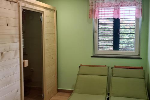 a room with three green chairs and a window at Family friendly house with a parking space Lokve, Gorski kotar - 19457 in Lokve