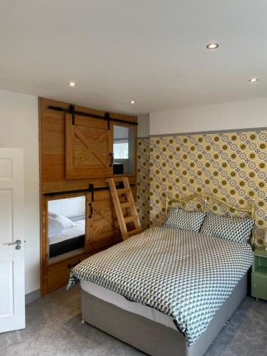 a bedroom with a bed and a wooden wall at Canty’s 