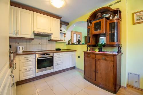 a kitchen with yellow walls and white cabinets at Family friendly house with a parking space Lokve, Gorski kotar - 19457 in Lokve
