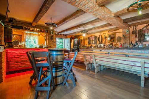 a bar with chairs and a table with a barrel at Family friendly house with a parking space Lokve, Gorski kotar - 19457 in Lokve