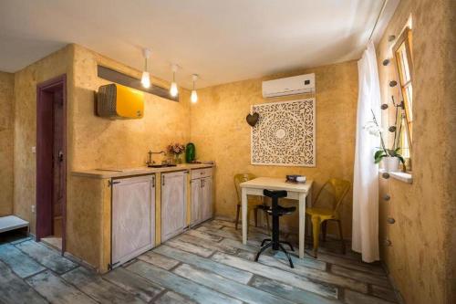 a kitchen with a table and a desk in it at Apartments by the sea Veli Losinj, Losinj - 19620 in Veli Lošinj