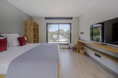 a bedroom with a large bed and a tv at Luxury Zen in Châteauneuf