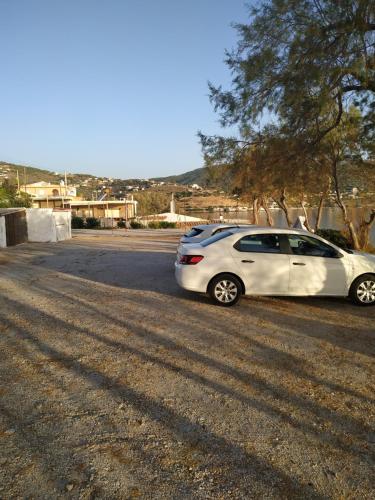 a white car parked on the side of a road at Daskalio Beach Hotel in Keratea