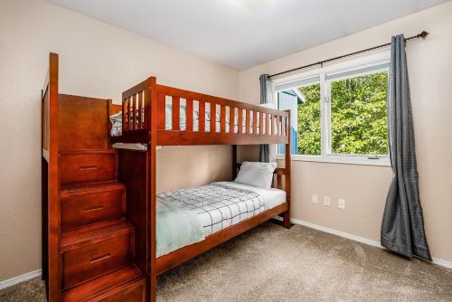 a bedroom with a bunk bed and a window at Carriage House at Ashley in Anchorage