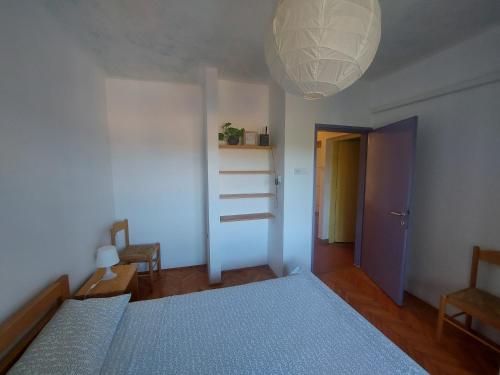 a bedroom with two beds and a light fixture at Apartment Iva Pula in Banjole