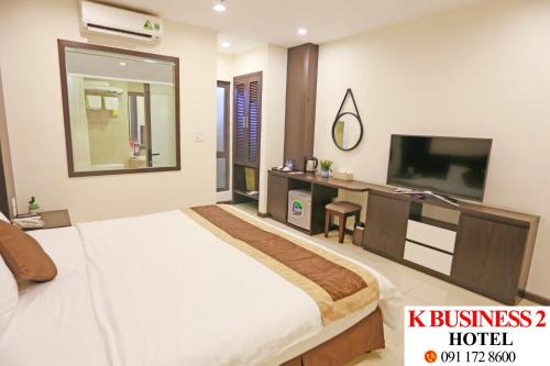 a hotel room with a large bed and a television at K Business 2 Hotel My Dinh 미딩 in Hanoi