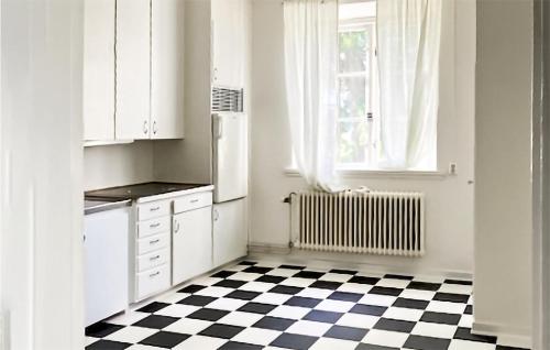 a kitchen with a black and white checkered floor at Cozy Apartment In Kristinehamn in Edet