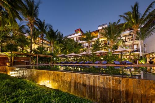 a resort with a pool with lounge chairs and umbrellas at Z Hotel & Z2 Hotel in Nungwi