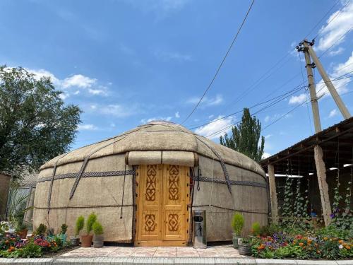 a large dome shaped building with a wooden door at Naryn Guest House in Naryn
