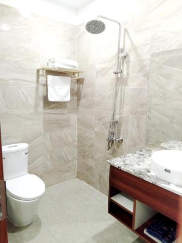 a bathroom with a toilet and a shower and a sink at The King Hotel - Condotel Thai Nguyen in Thái Nguyên