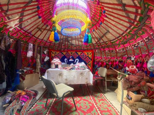 a room with a circus tent with a table and chairs at Naryn Guest House in Naryn