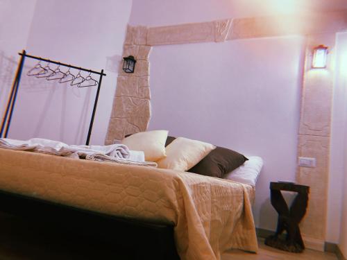a bedroom with a bed with a stone fireplace at LE ANTICHE MURA in Vallecorsa