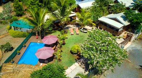 an aerial view of a resort with a pool and umbrellas at LA CASE BOIS CRÉOLE in Albion