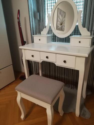 a white dressing table with a mirror and a stool at APARTMAN D&D*** in Varaždin