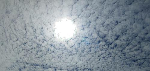 a sky filled with clouds with the sun in the middle at Ailama Guesthouse in Mestia