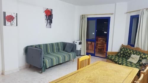 a living room with a couch and a table at Golden Beach 1 for family in Ras Sedr