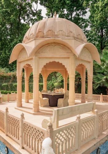 a gazebo in the middle of a garden at LP Vilas in Dehradun
