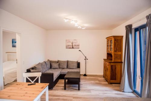 a living room with a couch and a table at Ferienwohnung Bad Vilbel in Bad Vilbel