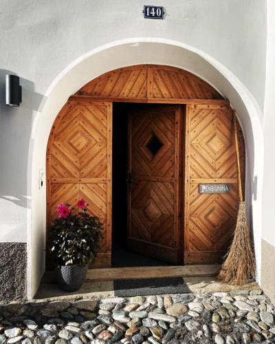 a wooden garage door with a vase of flowers at Pensiunina - Pension - Sent in Sent