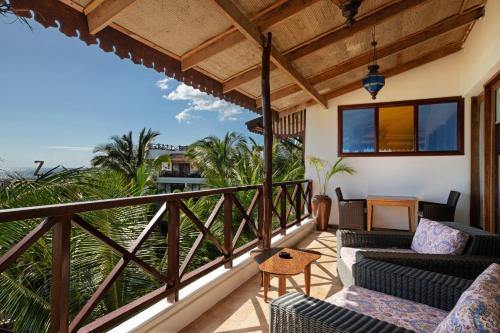 a balcony with furniture and a view of the ocean at Z Hotel & Z2 Hotel in Nungwi