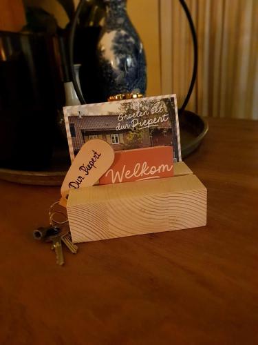 a stack of books on a table with a pair of keys at Vakantiehuis Dur Piepert in Eys