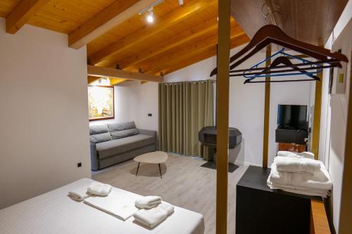 a room with a bed and a living room at Hotel Semajo in Vlorë